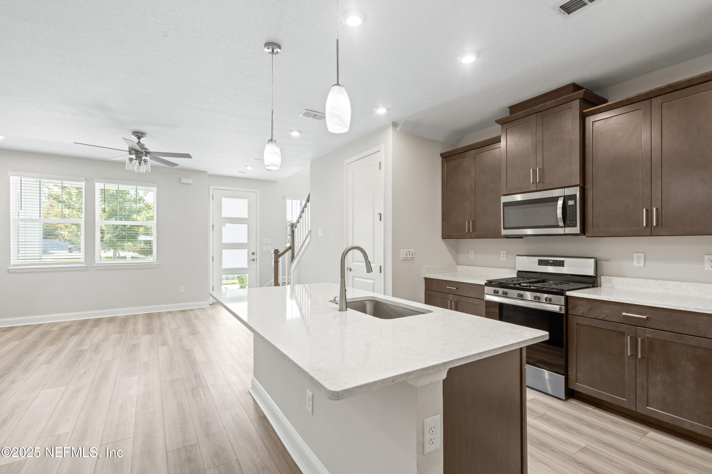 3524 Oystercatcher Way Jacksonville, FL 32224 - Photo 7 of 40 a kitchen with kitchen island a sink stainless steel appliances and window