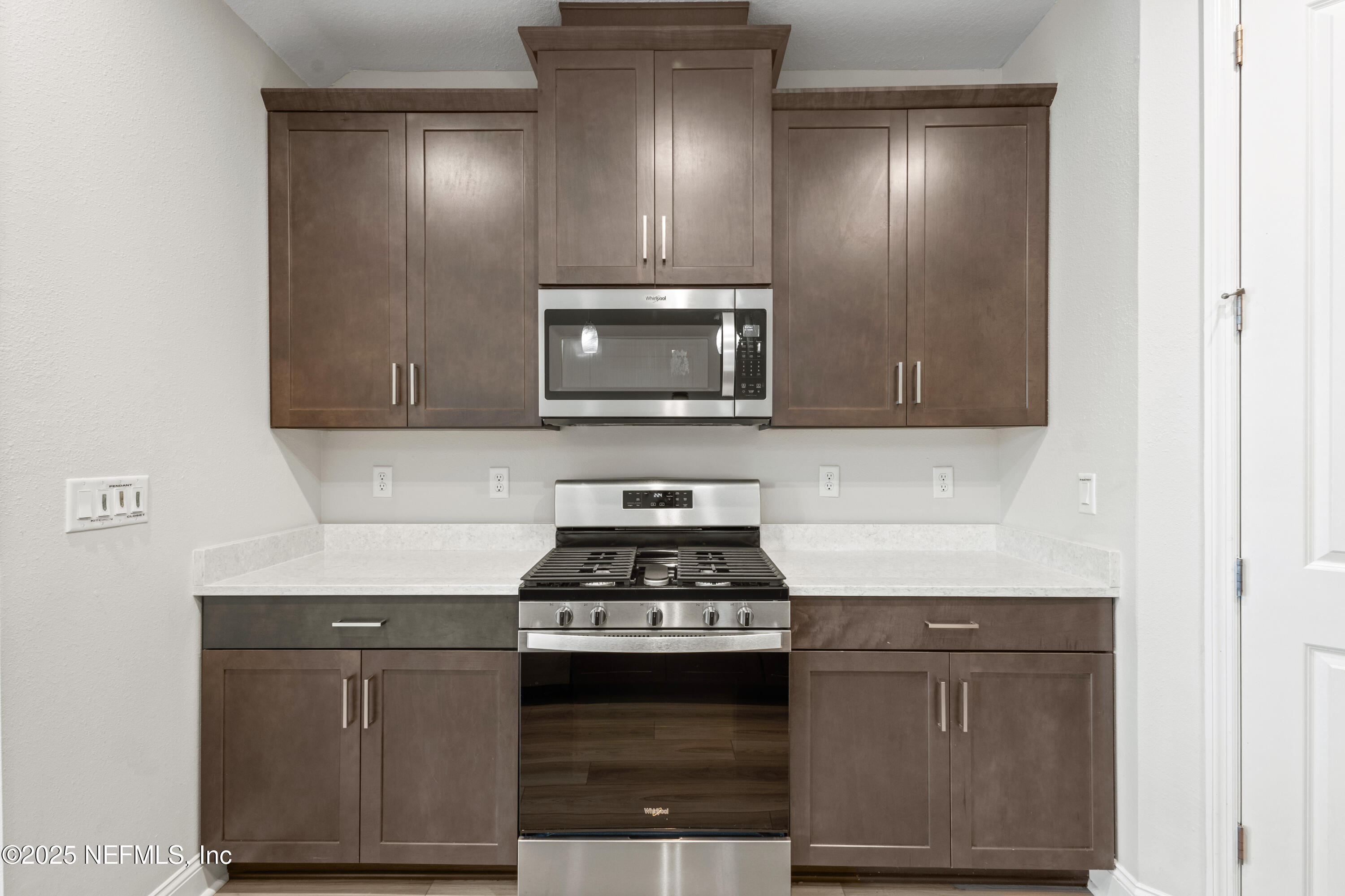 3524 Oystercatcher Way Jacksonville, FL 32224 - Photo 10 of 40 a kitchen with granite countertop a stove and a microwave