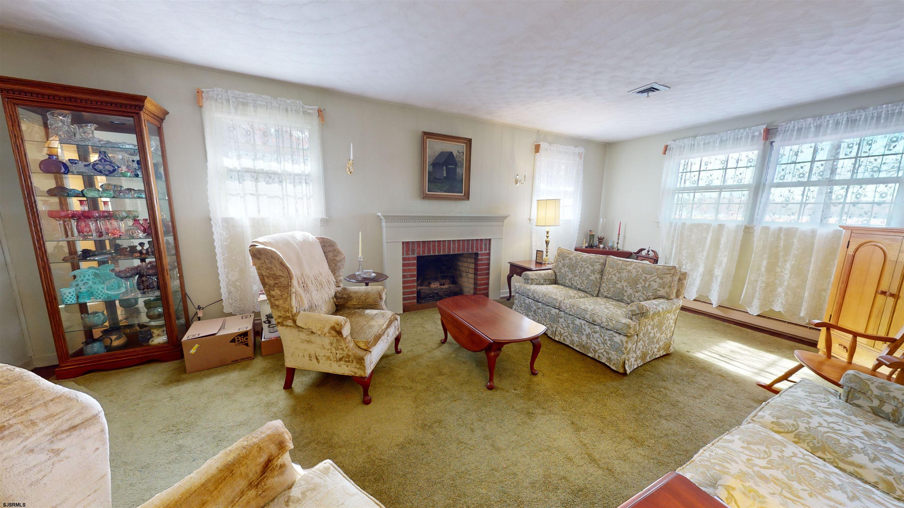 508 Lehigh Road South Glassboro, NJ 08028 - Photo 18 of 24 a living room with furniture and a fireplace