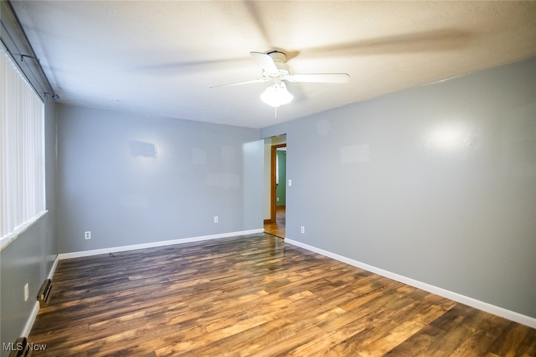 91 Mike Street Washington, WV 26181 - Photo 15 of 42 Unfurnished room featuring dark wood-style floors and a ceiling fan
