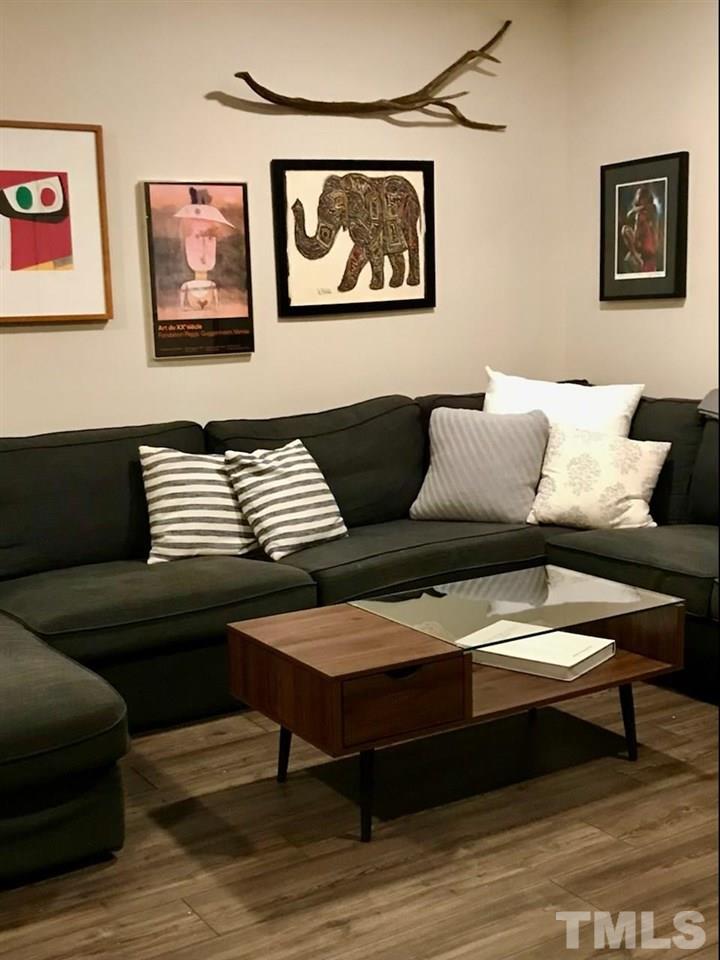 2516 Avent Ferry Road, Unit 101 Raleigh, NC 27606 - Photo 2 of 27 a living room with furniture and a wooden floor