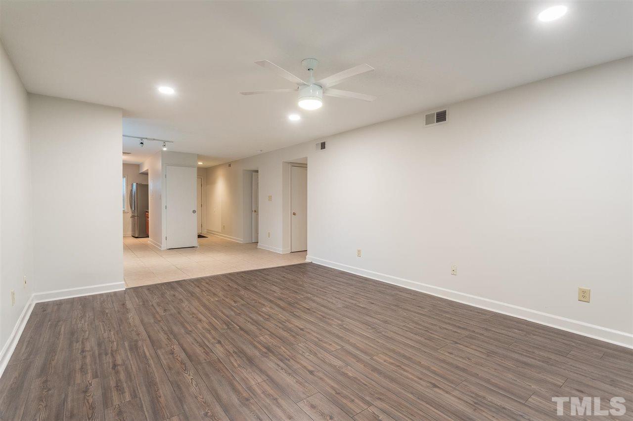 2516 Avent Ferry Road, Unit 101 Raleigh, NC 27606 - Photo 11 of 27 a view of an empty room with wooden floor