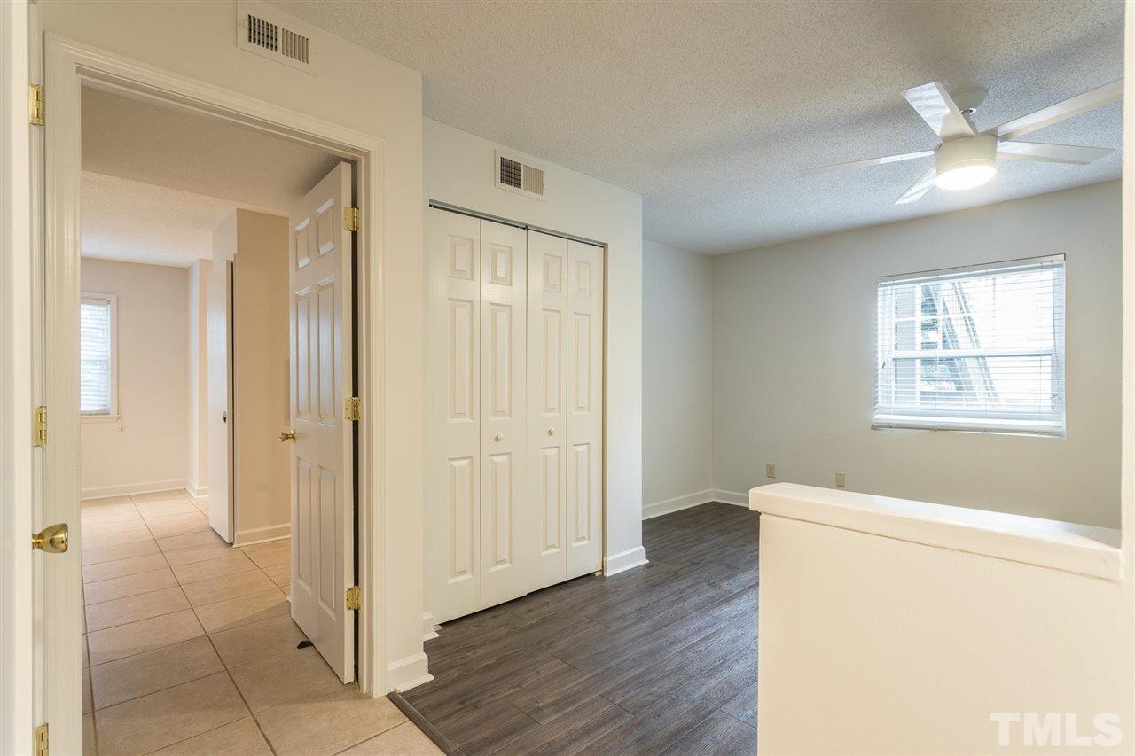 2516 Avent Ferry Road, Unit 101 Raleigh, NC 27606 - Photo 14 of 27 a view of livingroom with hardwood floor and hallway
