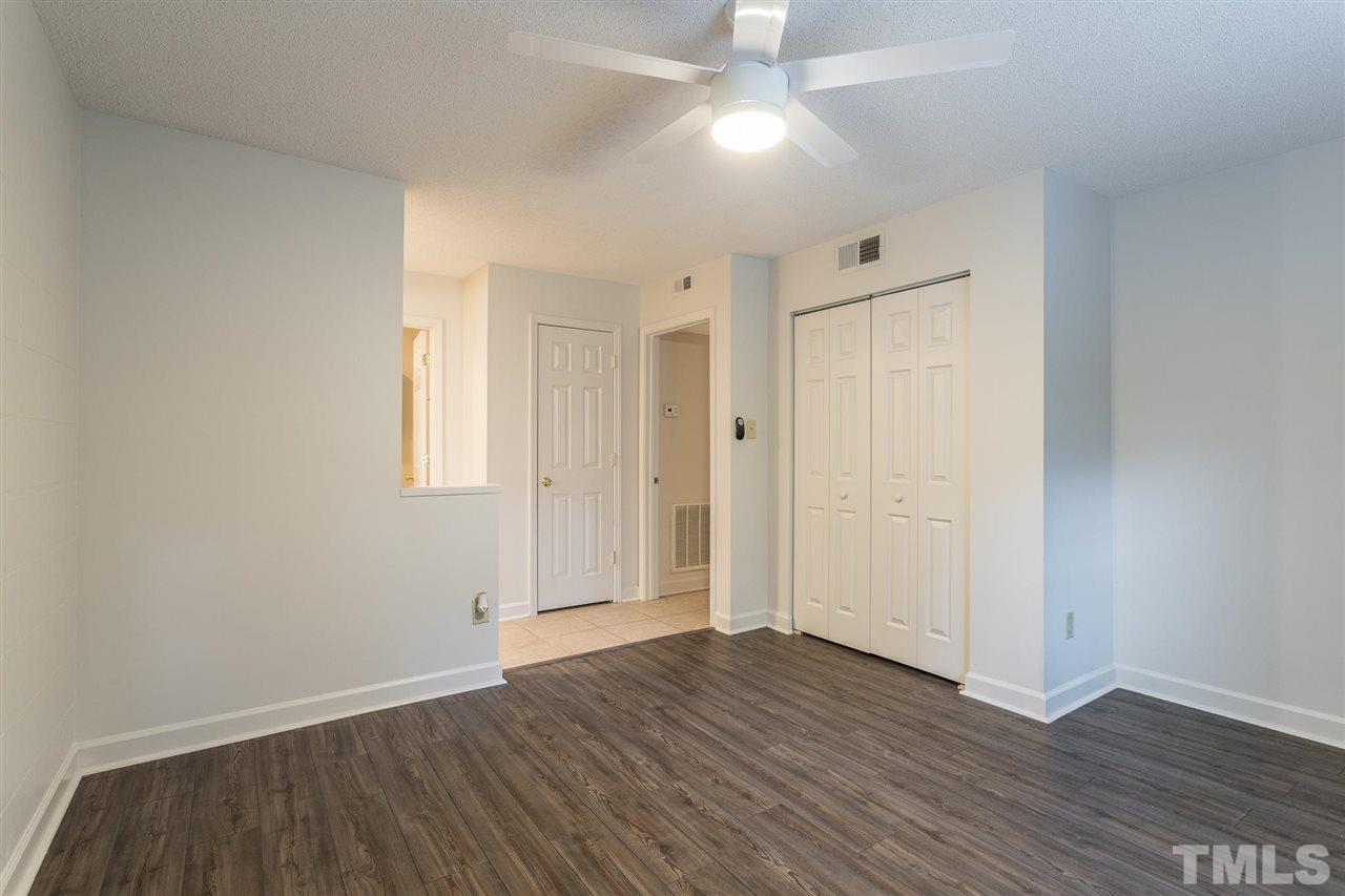 2516 Avent Ferry Road, Unit 101 Raleigh, NC 27606 - Photo 16 of 27 an empty room with wooden floor and windows