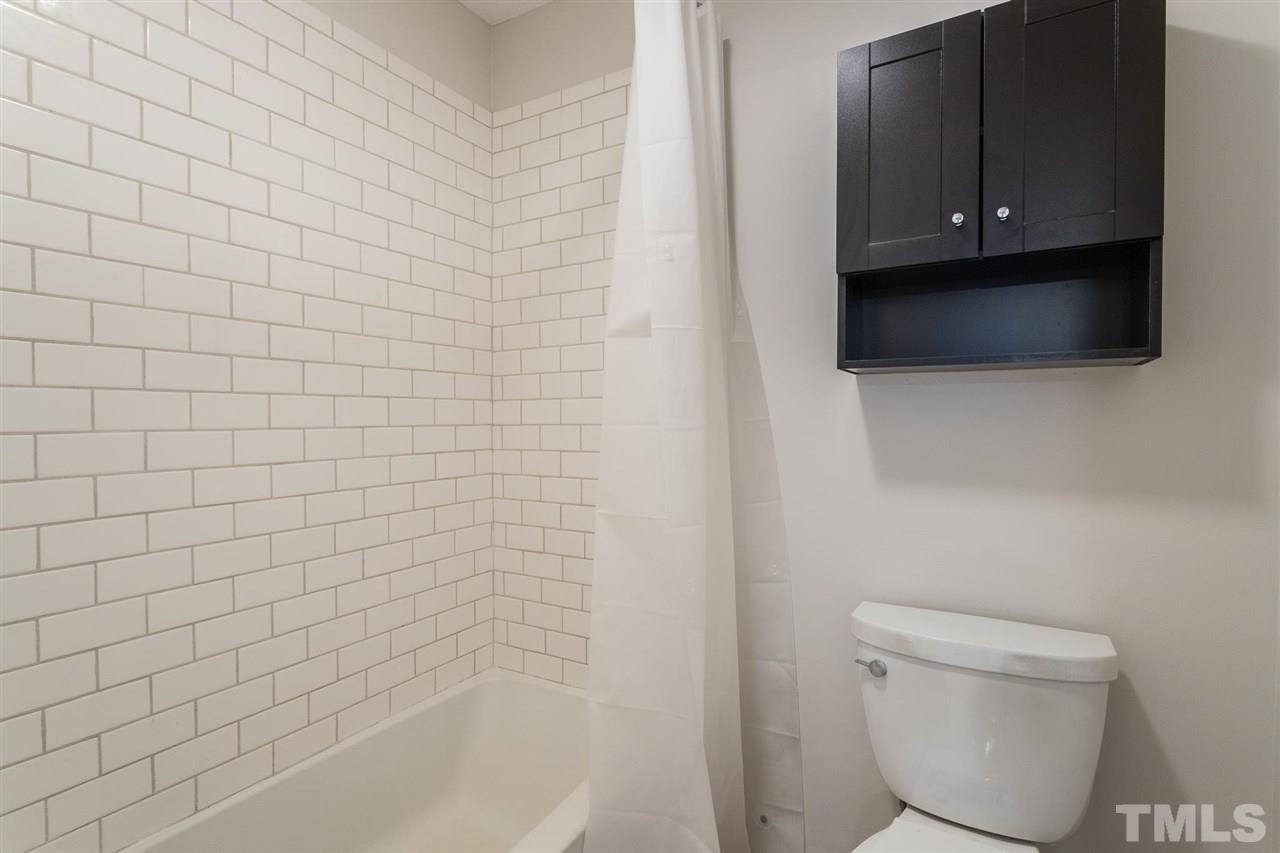2516 Avent Ferry Road, Unit 101 Raleigh, NC 27606 - Photo 19 of 27 a bathroom with a toilet and a bathtub
