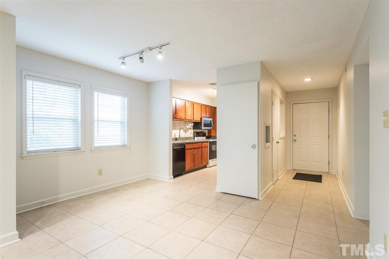 2516 Avent Ferry Road, Unit 101 Raleigh, NC 27606 - Photo 8 of 27 a view of a kitchen with a refrigerator and a stove