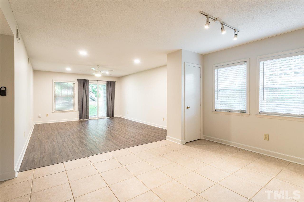 2516 Avent Ferry Road, Unit 101 Raleigh, NC 27606 - Photo 9 of 27 a view of empty room with wooden floor and fan
