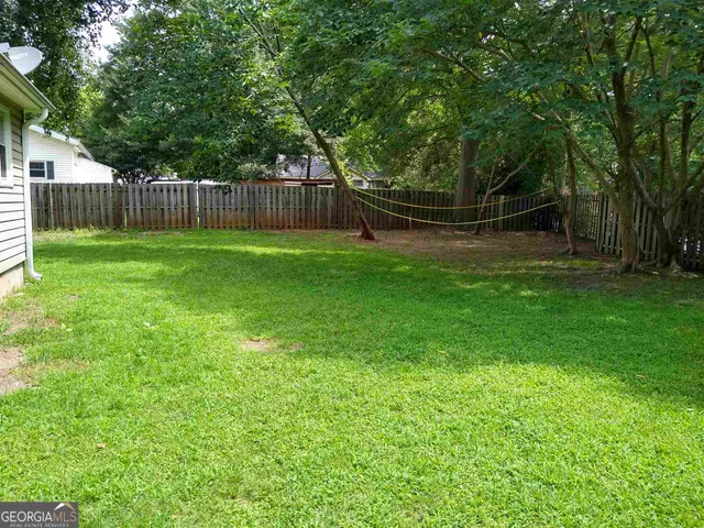 a backyard of a house with lots of green space