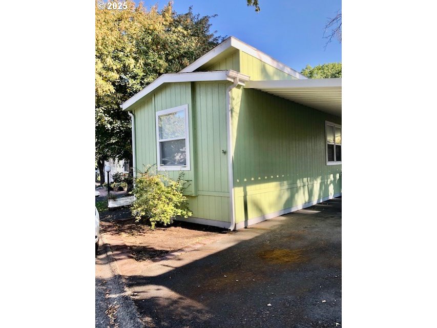 a yellow house with tree in front of it