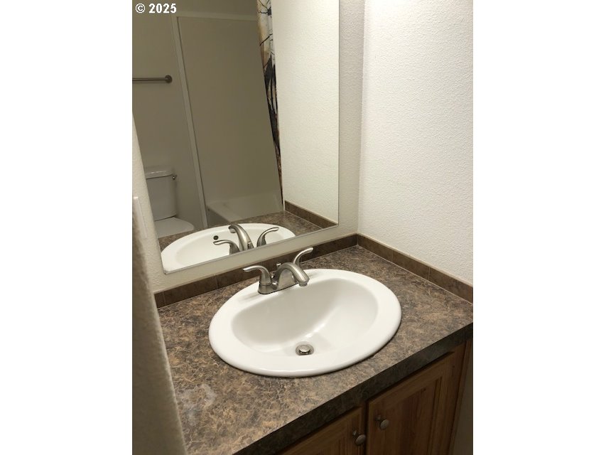 1475 Green Acres Road, Unit 76 Eugene, OR 97408 - Photo 14 of 22 a bathroom with a sink and a mirror