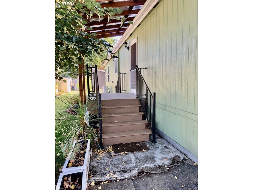 1475 Green Acres Road, Unit 76 Eugene, OR 97408 - Photo 2 of 22 a view of entryway with stairs and wooden floor