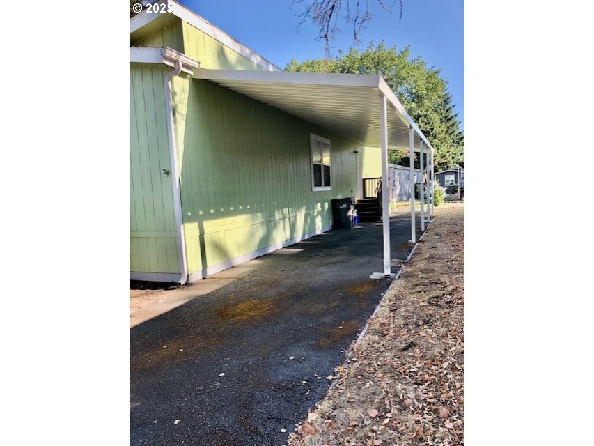 1475 Green Acres Road, Unit 76 Eugene, OR 97408 - Photo 3 of 22 a view of a porch with couches and table
