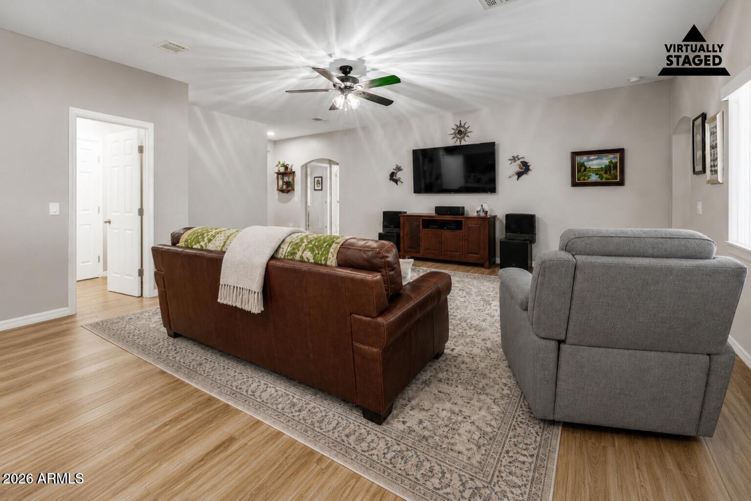 614 North Tomahawk Road Apache Junction, AZ 85119 - Photo 7 of 44 a living room with furniture and a flat screen tv