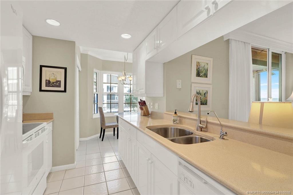 5700 Northeast Island Cove Way, Unit 4301 Stuart, FL 34996 - Photo 17 of 45 a kitchen that has a sink and a stove top oven