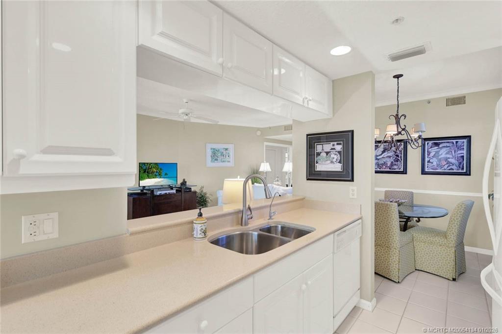 5700 Northeast Island Cove Way, Unit 4301 Stuart, FL 34996 - Photo 19 of 45 a kitchen that has a sink and cabinets in it