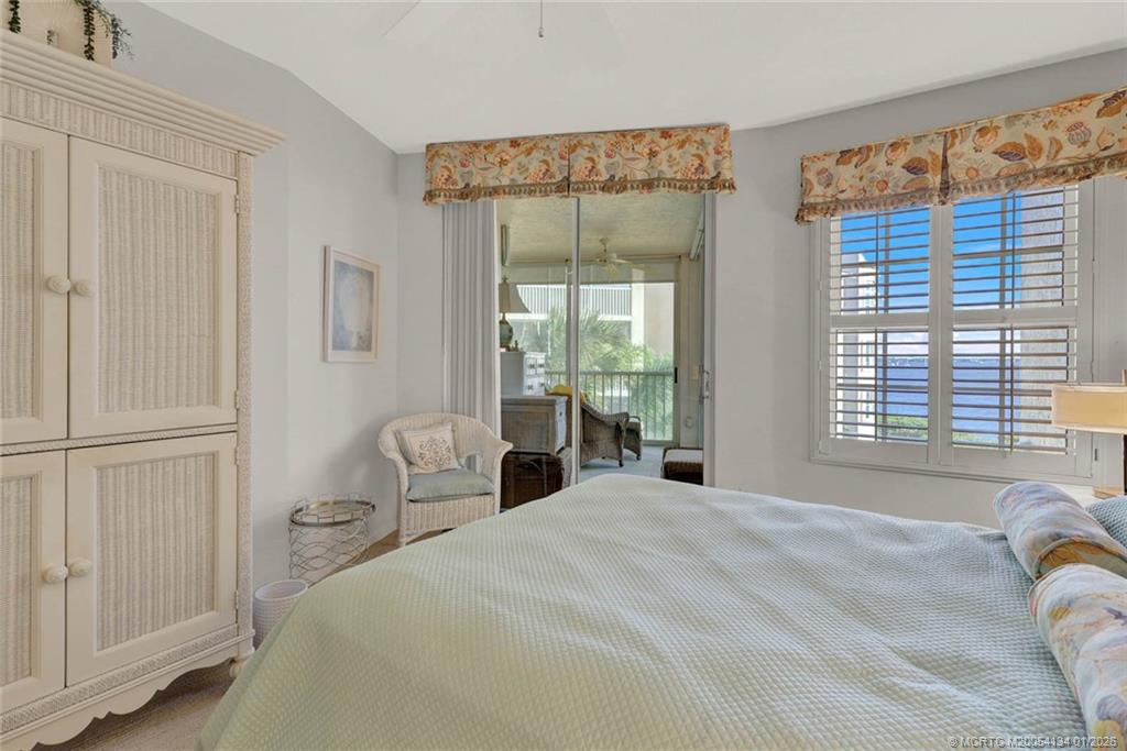 5700 Northeast Island Cove Way, Unit 4301 Stuart, FL 34996 - Photo 30 of 45 a bedroom with a bed and a large window