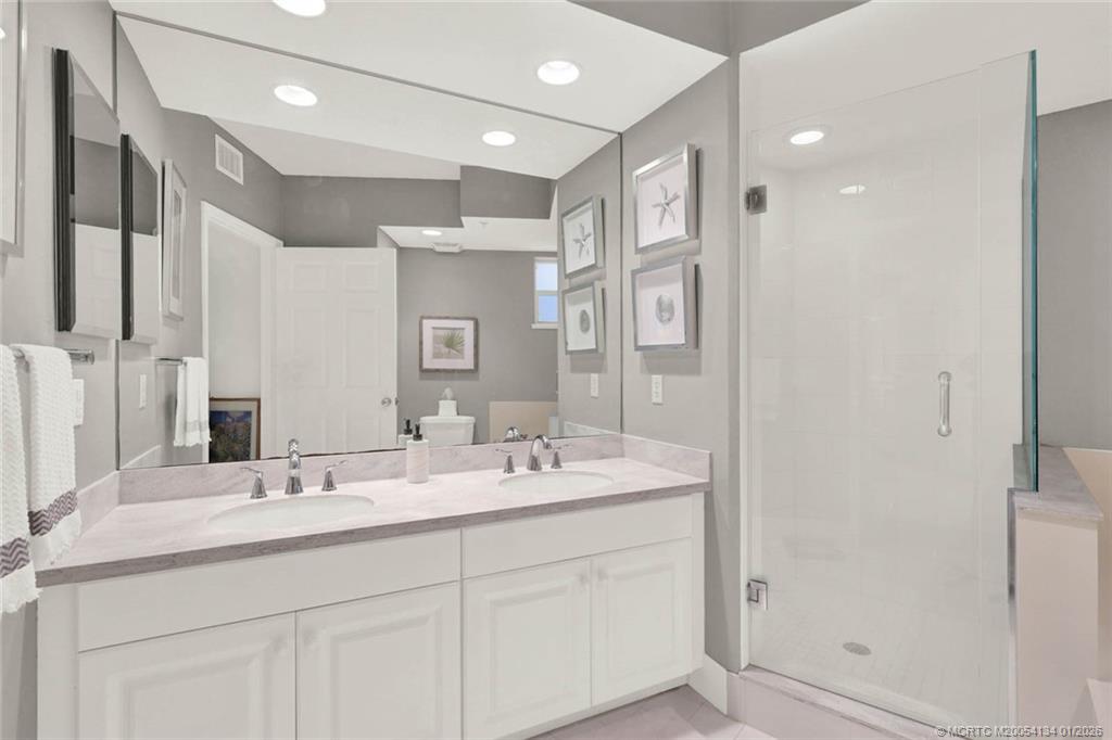 5700 Northeast Island Cove Way, Unit 4301 Stuart, FL 34996 - Photo 33 of 45 a bathroom with a double vanity sink mirror and double
