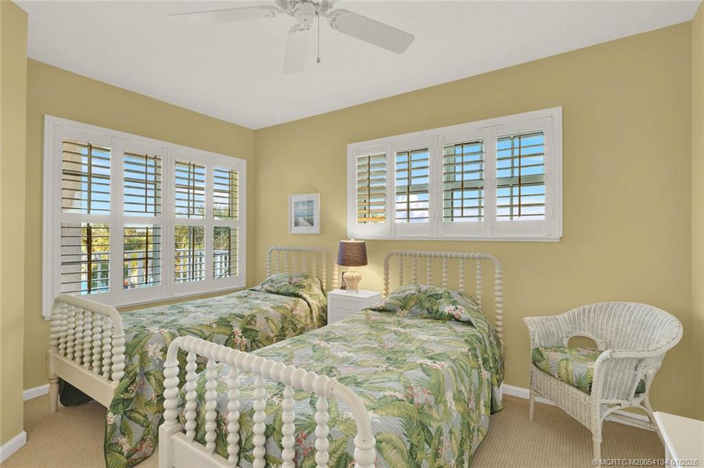5700 Northeast Island Cove Way, Unit 4301 Stuart, FL 34996 - Photo 36 of 45 a bedroom with a bed and a window