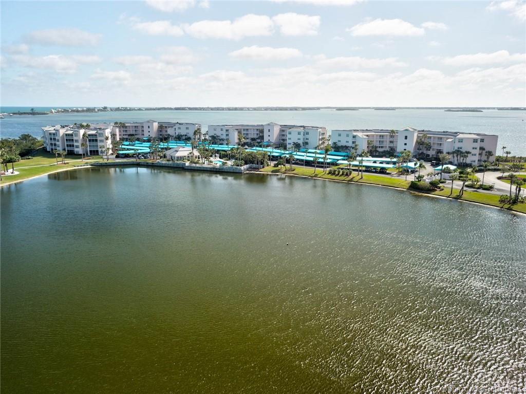5700 Northeast Island Cove Way, Unit 4301 Stuart, FL 34996 - Photo 43 of 45 a view of a lake with boats and trees in the background