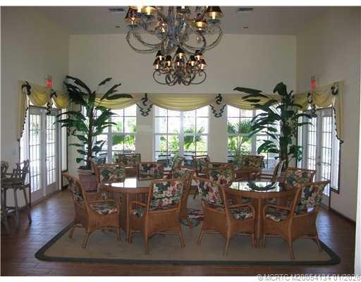 5700 Northeast Island Cove Way, Unit 4301 Stuart, FL 34996 - Photo 45 of 45 a view of a dining room with furniture window and wooden floor