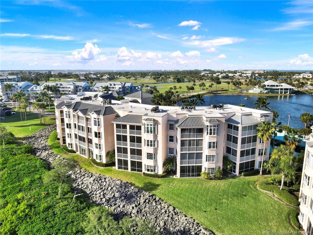 5700 Northeast Island Cove Way, Unit 4301 Stuart, FL 34996 - Photo 7 of 45 a view of a large building with a yard