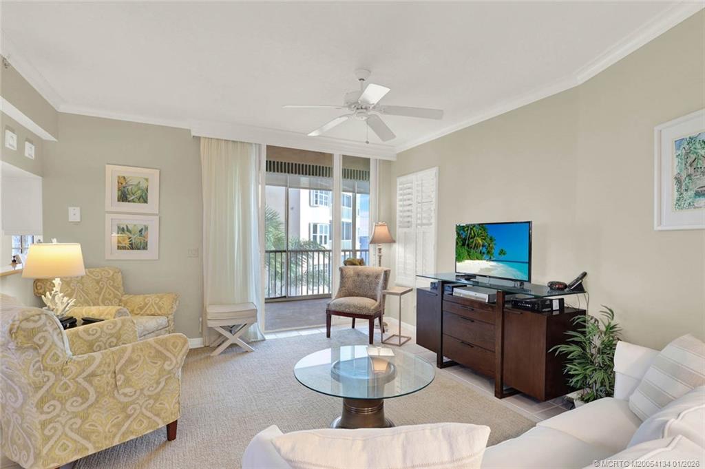 5700 Northeast Island Cove Way, Unit 4301 Stuart, FL 34996 - Photo 10 of 45 a living room with furniture a flat screen tv and a table