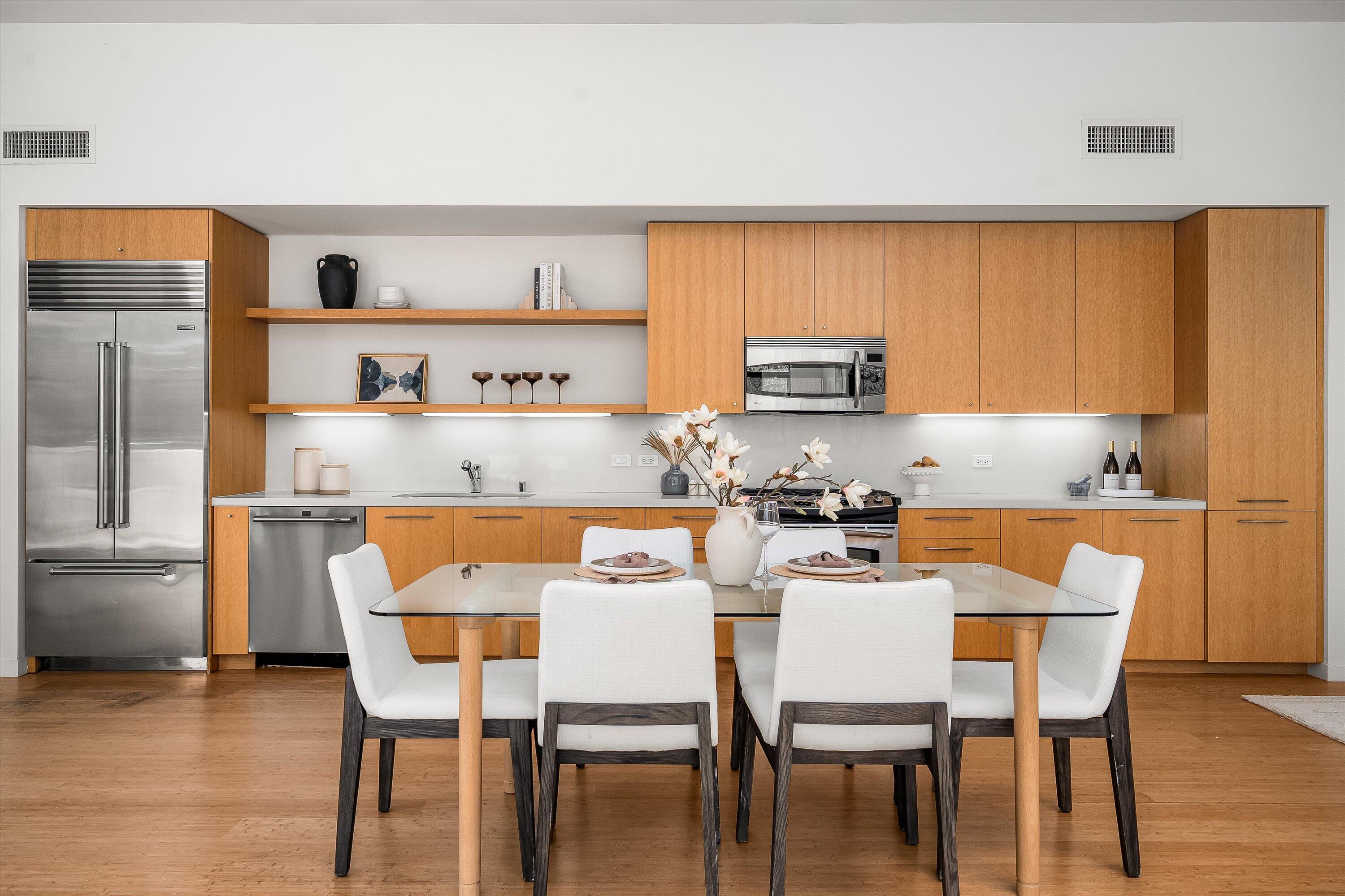 401 Chapala Street, Unit 214 Santa Barbara, CA 93101 - Photo 15 of 31 a kitchen with a dining table chairs and a refrigerator