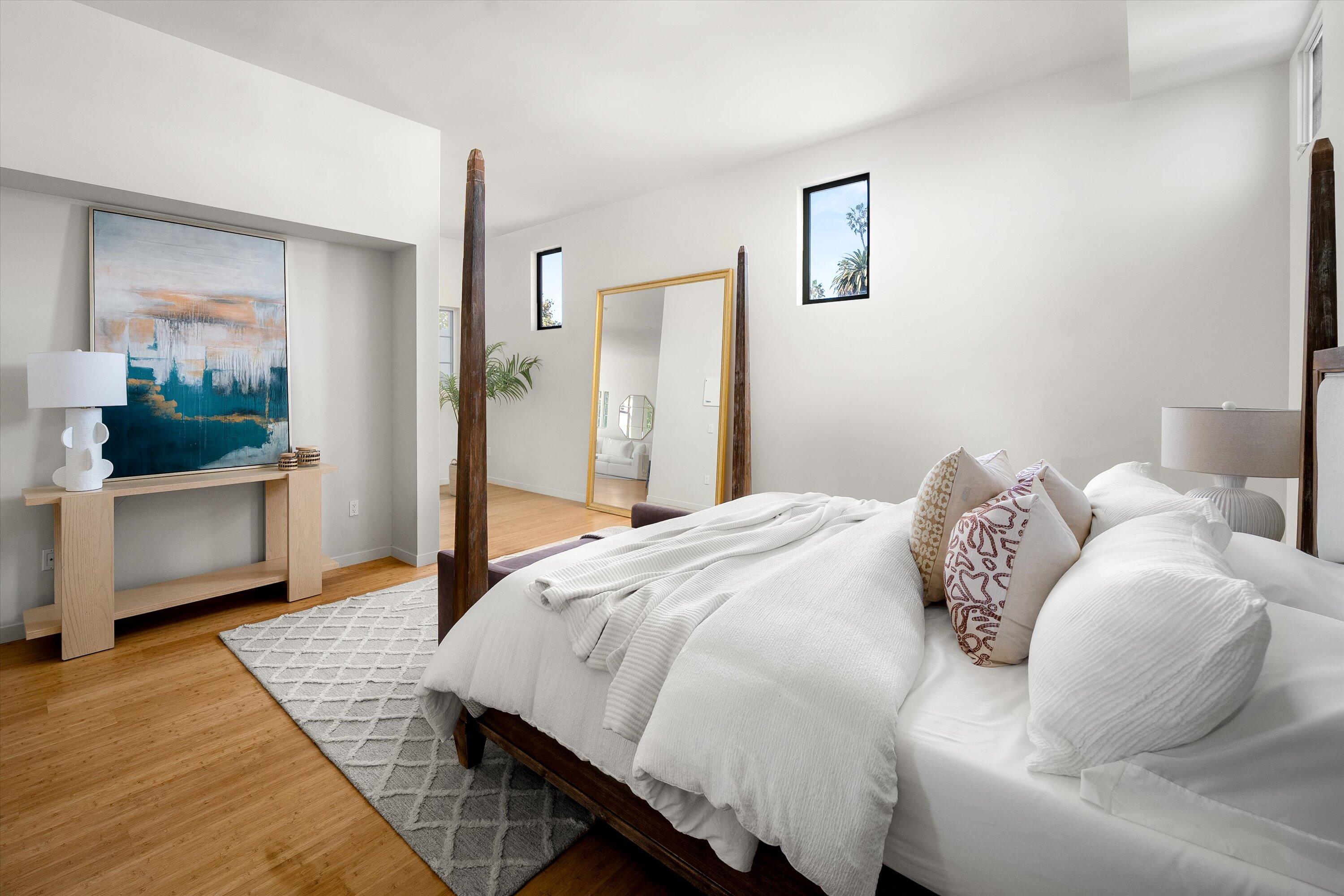 401 Chapala Street, Unit 214 Santa Barbara, CA 93101 - Photo 16 of 31 a bedroom with a bed and wooden floor