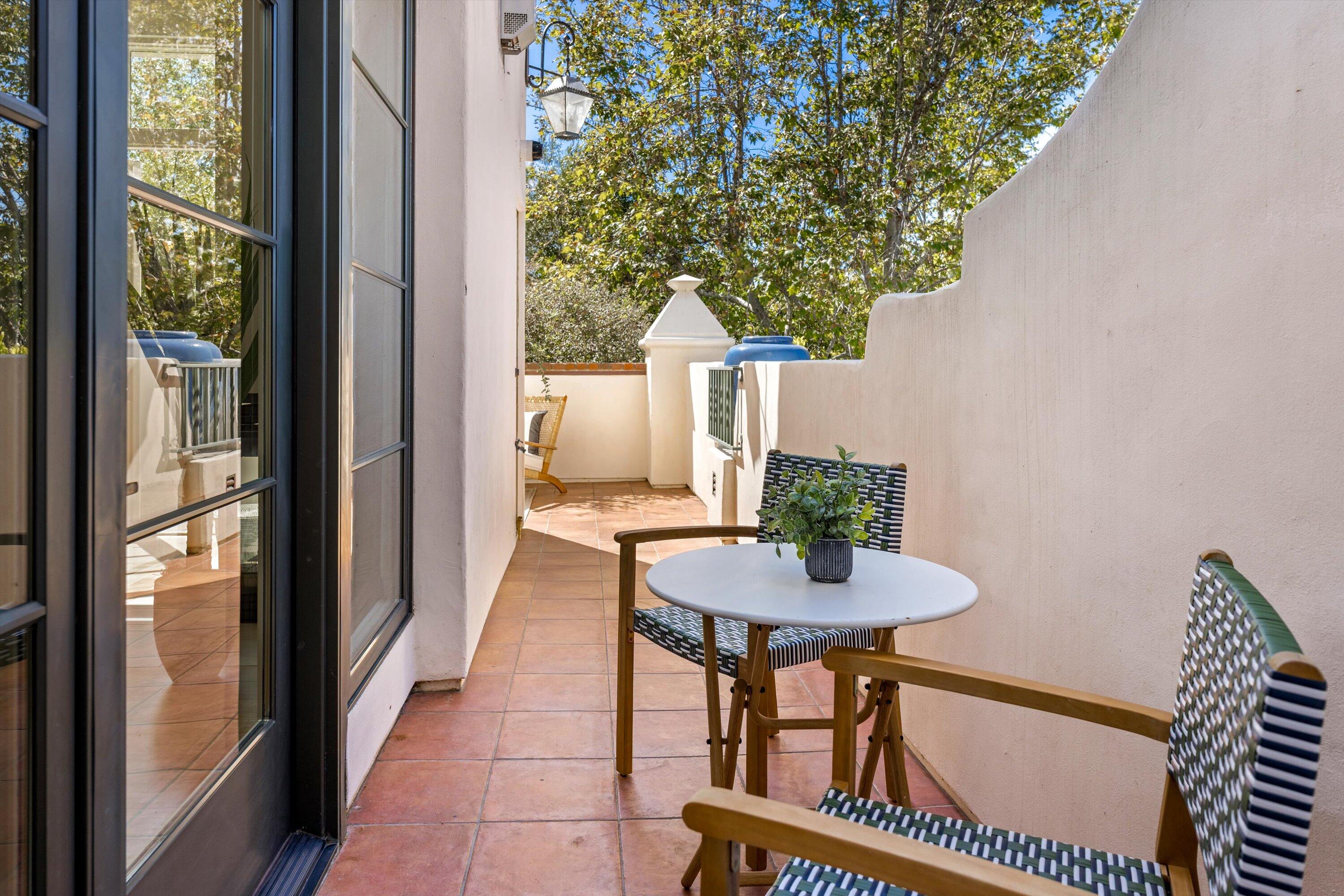 401 Chapala Street, Unit 214 Santa Barbara, CA 93101 - Photo 23 of 31 a balcony with table and chairs