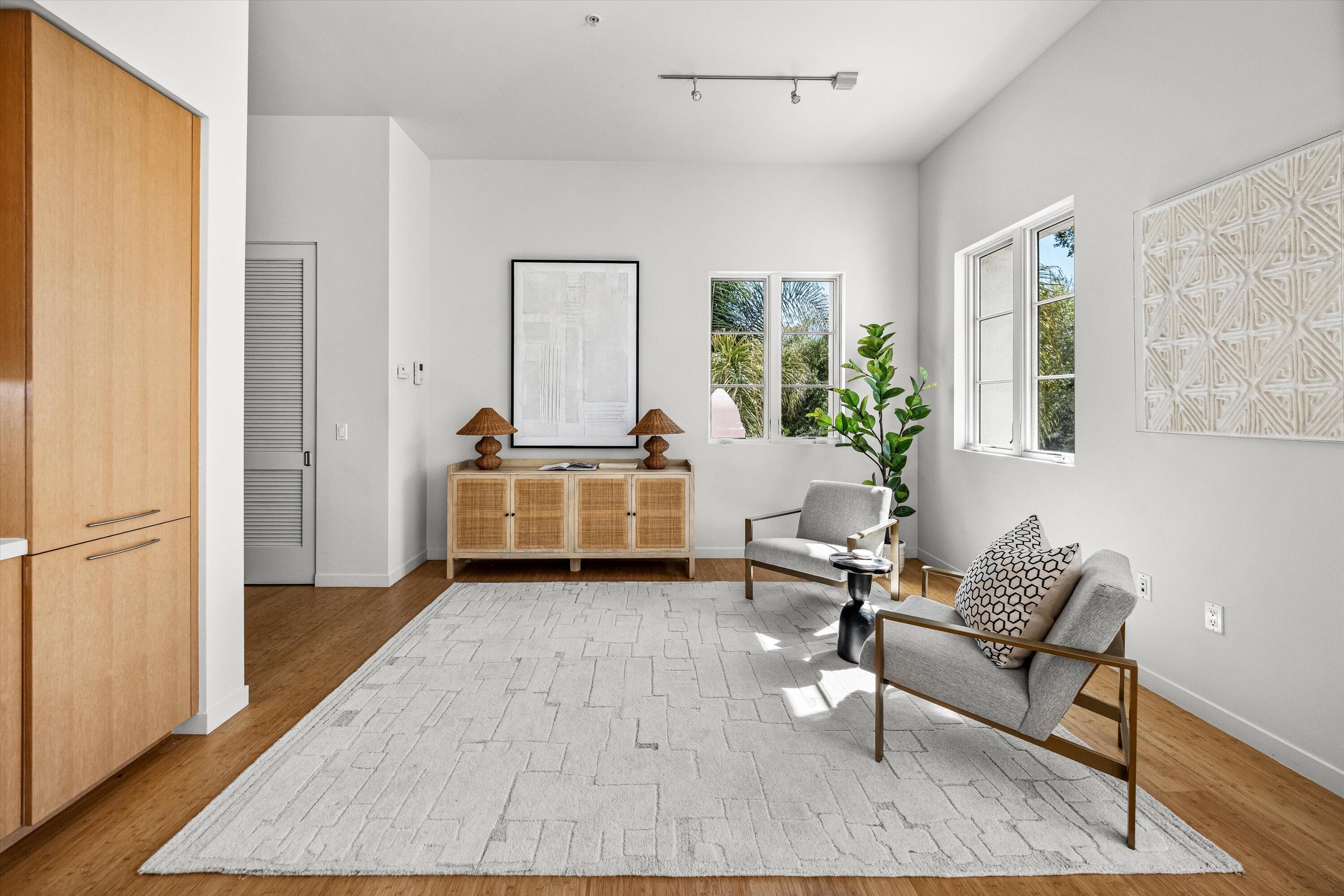 401 Chapala Street, Unit 214 Santa Barbara, CA 93101 - Photo 8 of 31 a living room with furniture and wooden floor