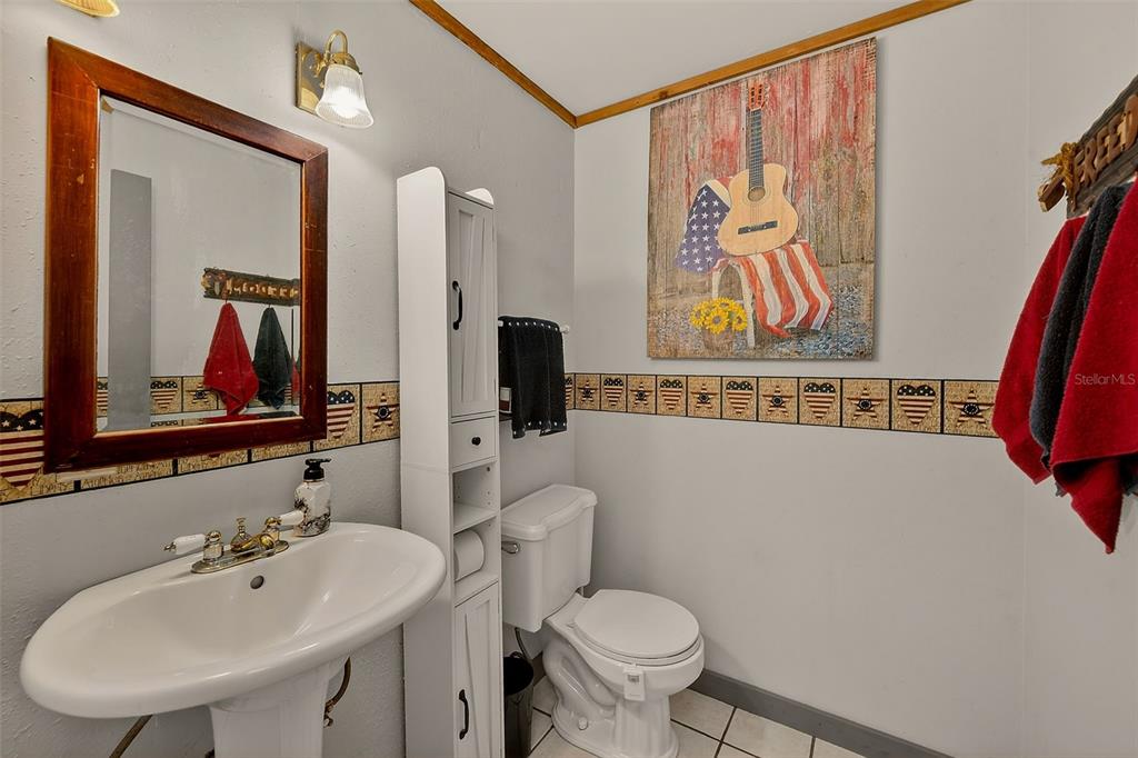 2635 North Dover Road Dover, FL 33527 - Photo 12 of 84 a bathroom with a toilet a sink and a mirror