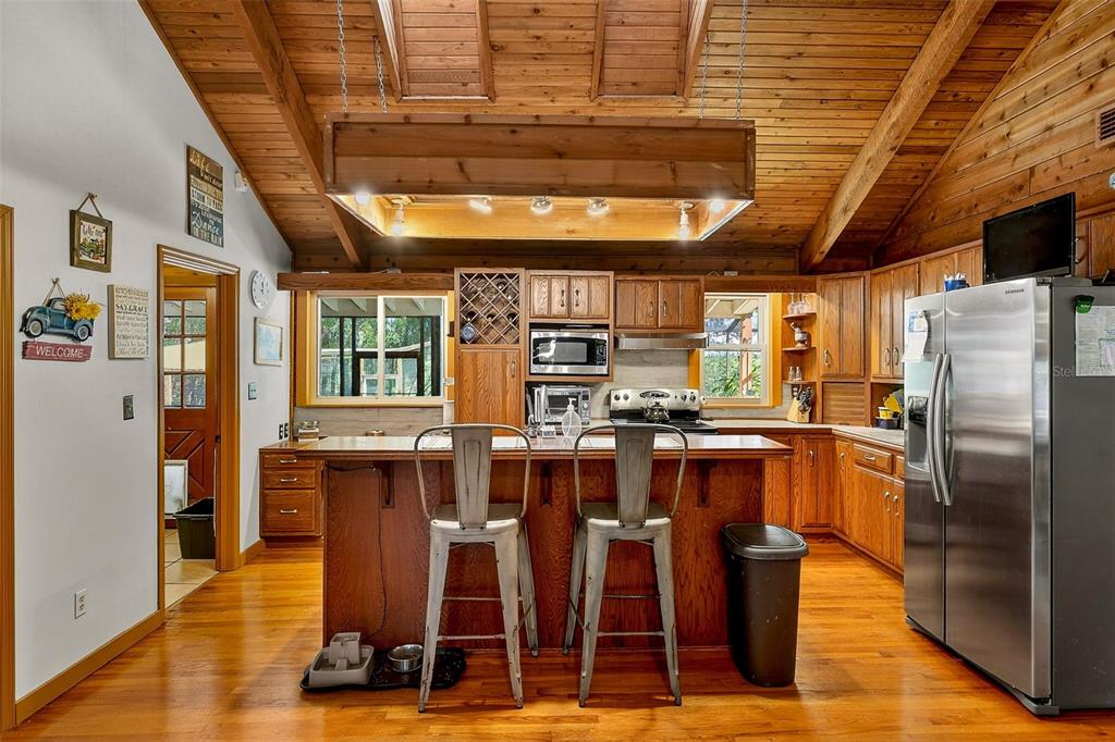 2635 North Dover Road Dover, FL 33527 - Photo 14 of 84 a room with stainless steel appliances kitchen island granite countertop a table chairs and a refrigerator