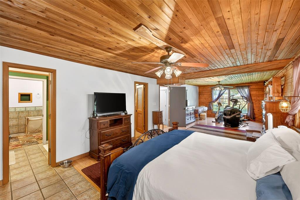 2635 North Dover Road Dover, FL 33527 - Photo 35 of 84 a bedroom with furniture and a flat screen tv