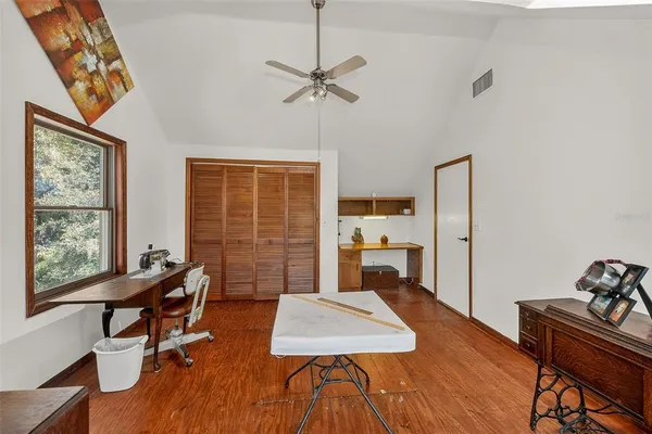 an aerial view of residential houses with outdoor space and trees