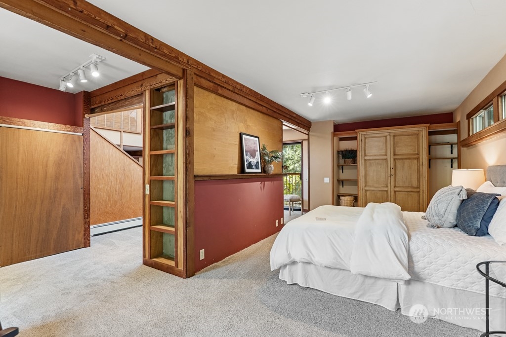 5610 Cape George Road Port Townsend, WA 98368 - Photo 16 of 37 a bedroom with a bed and a large window