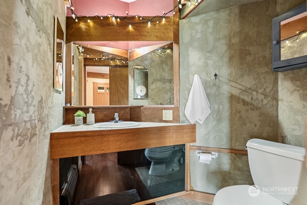 5610 Cape George Road Port Townsend, WA 98368 - Photo 18 of 37 a bathroom with a sink a toilet and a mirror