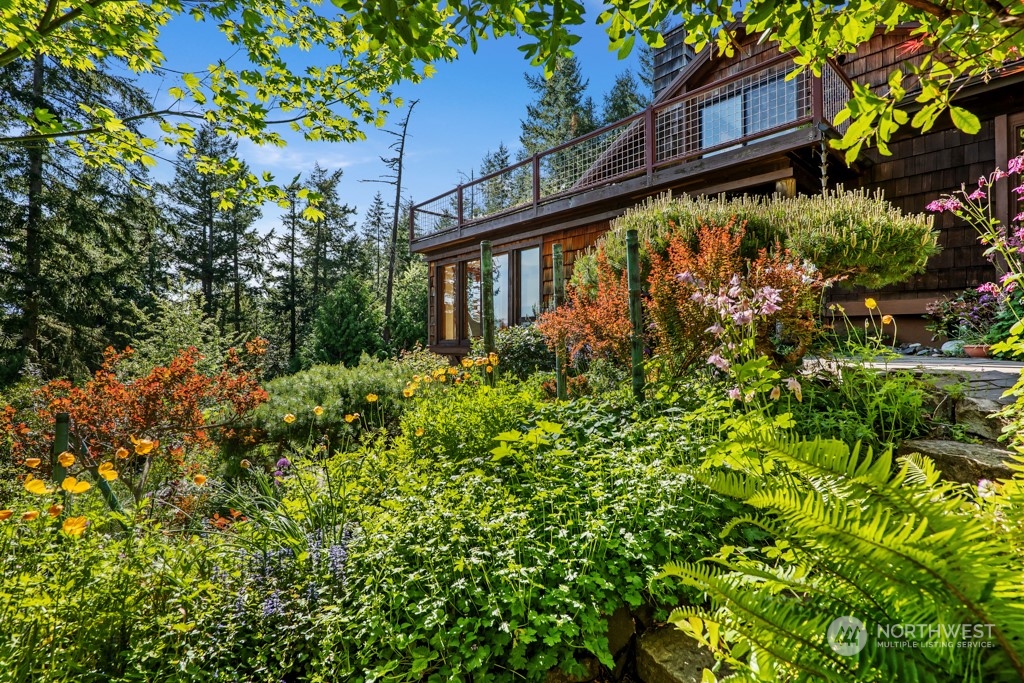 5610 Cape George Road Port Townsend, WA 98368 - Photo 26 of 37 a view of a house with a flower garden