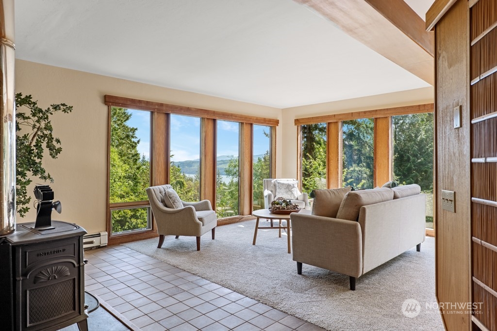 5610 Cape George Road Port Townsend, WA 98368 - Photo 3 of 37 a living room with furniture and floor to ceiling windows
