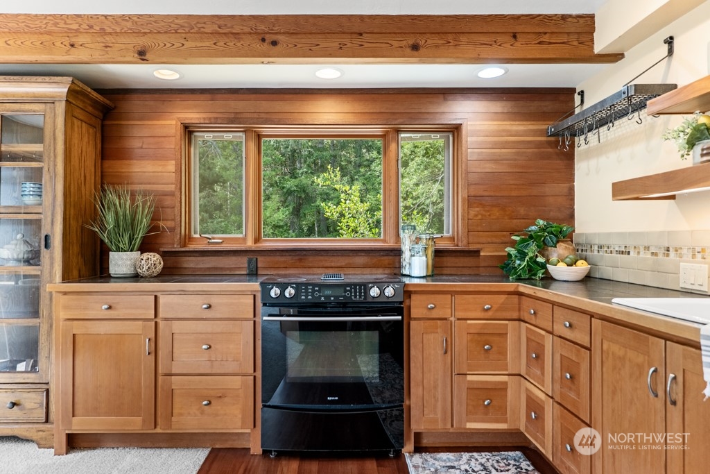 5610 Cape George Road Port Townsend, WA 98368 - Photo 8 of 37 a kitchen with granite countertop a stove and a sink