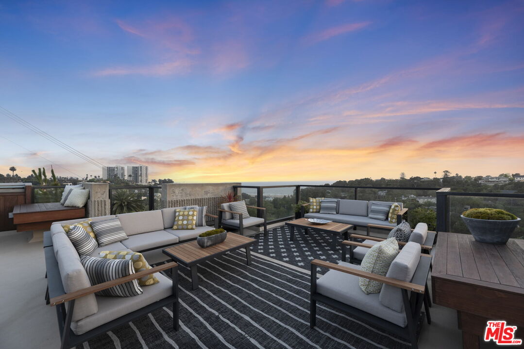 407 Upper Mesa Road Santa Monica, CA 90402 - Photo 13 of 54 a view of a roof deck with couches and potted plants