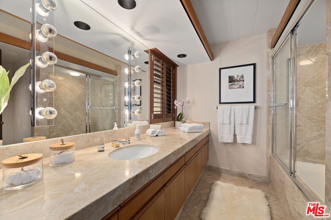 407 Upper Mesa Road Santa Monica, CA 90402 - Photo 34 of 54 a en suite bathroom with a double vanity sink a mirror and a shower