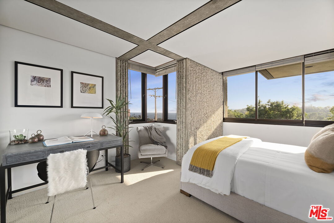 407 Upper Mesa Road Santa Monica, CA 90402 - Photo 38 of 54 a bedroom with a bed and a large window