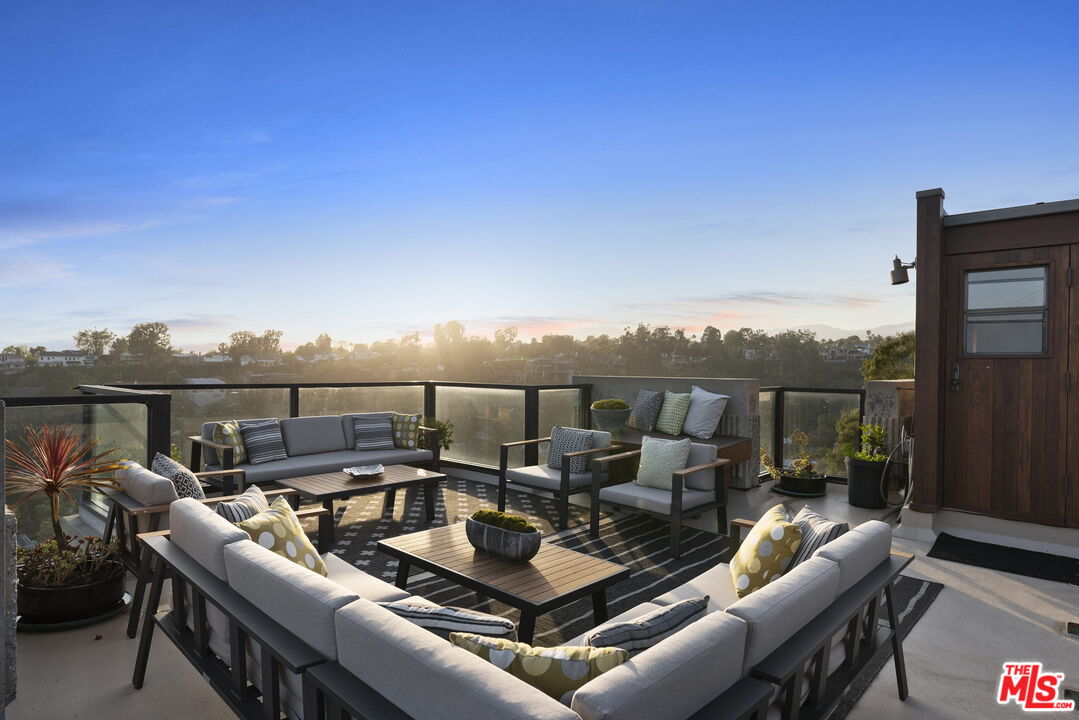 407 Upper Mesa Road Santa Monica, CA 90402 - Photo 46 of 54 a view of a roof deck with couches and sky view