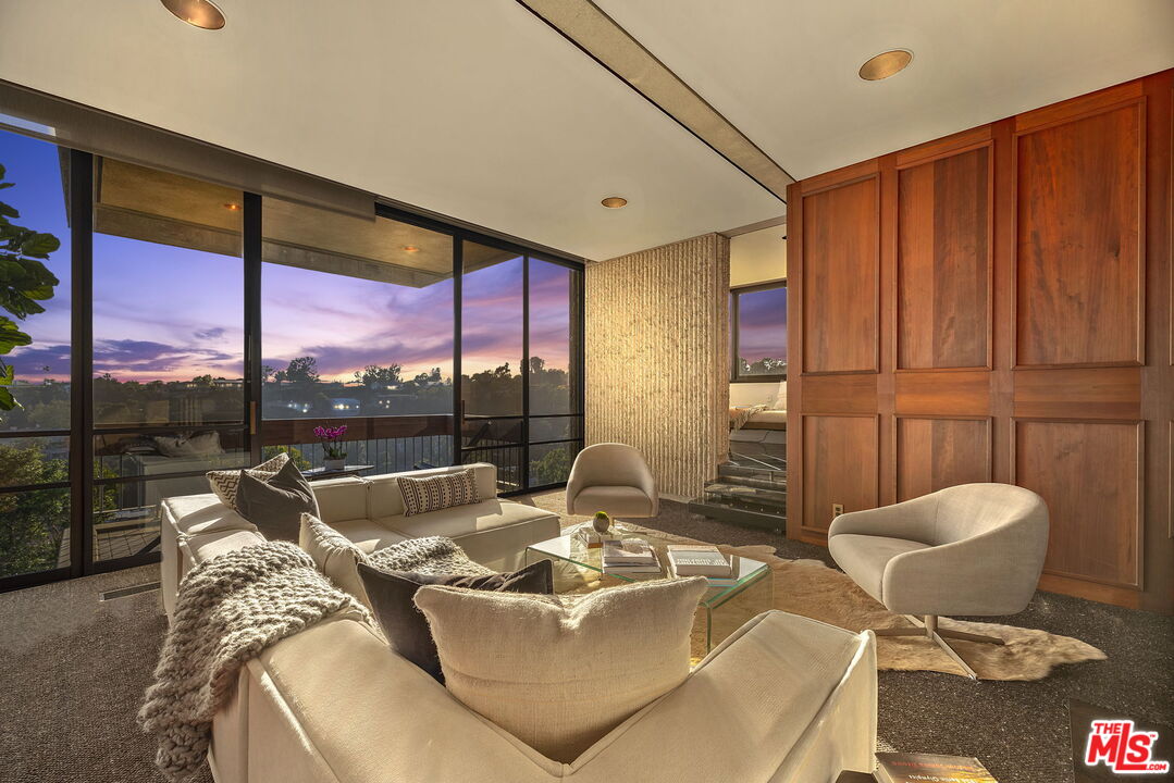 407 Upper Mesa Road Santa Monica, CA 90402 - Photo 5 of 54 a living room with furniture a rug and a large window