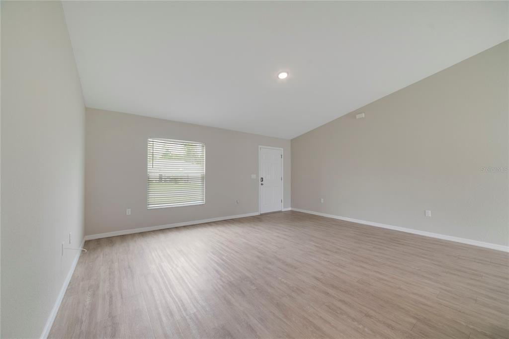 16271 Southwest 27th Terrace Road Ocala, FL 34473 - Photo 19 of 21 an empty room with wooden floor and windows