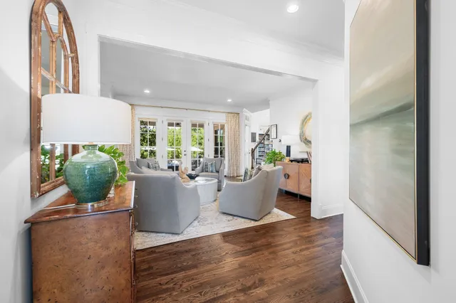 a living room with a couch a bookshelf and a fireplace