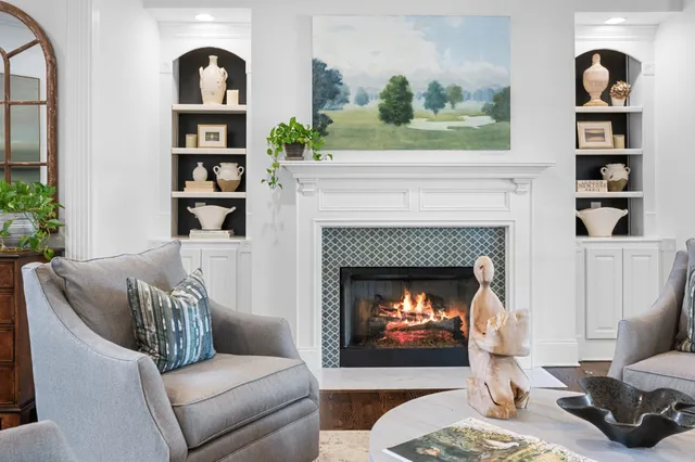 a living room with furniture kitchen view and a large window