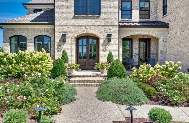 a front view of a house with a garden