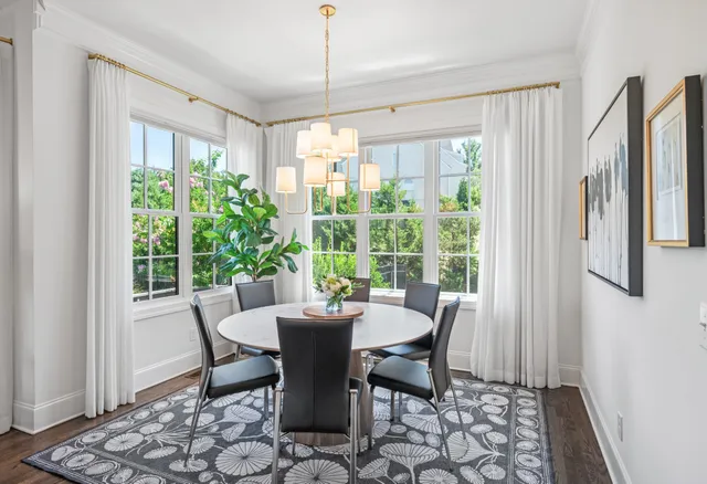 a living room with a table and a chair