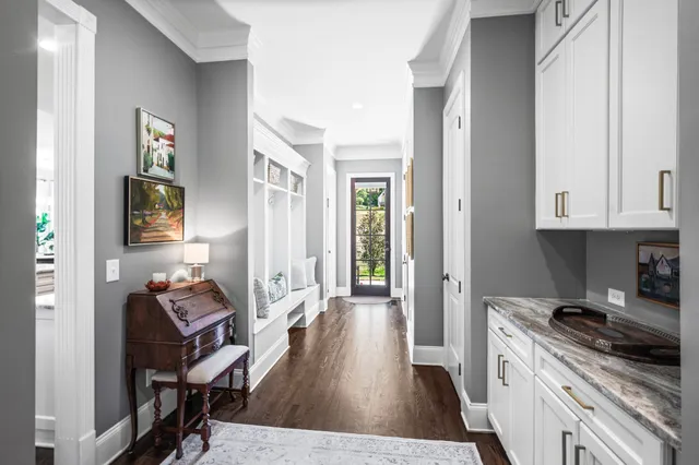 a bedroom with a large bed potted plant and a large window